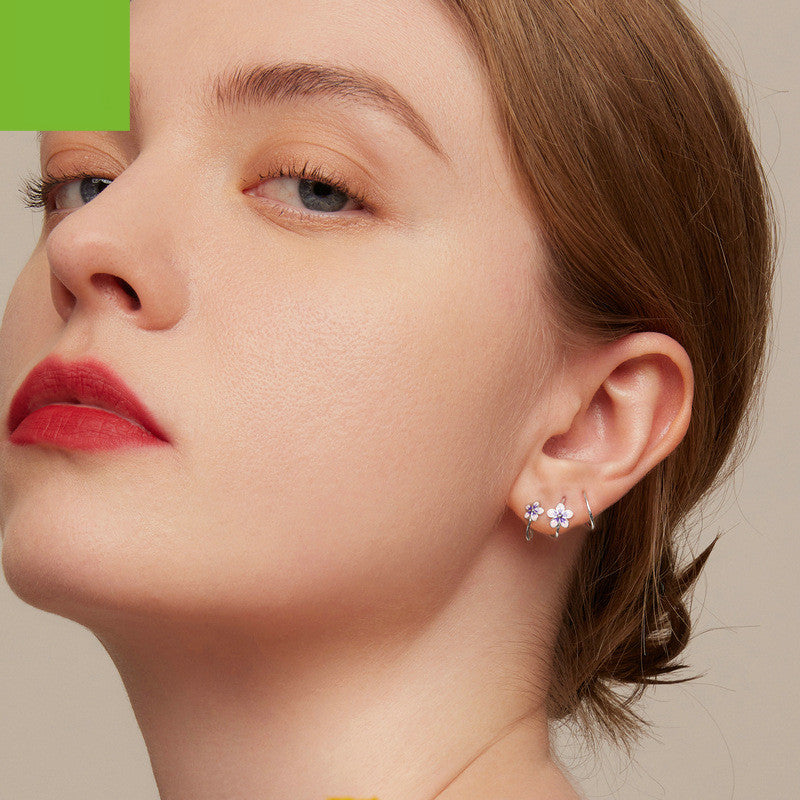Elegant personalized zircon earrings worn by a woman, adding a touch of sophistication to her look