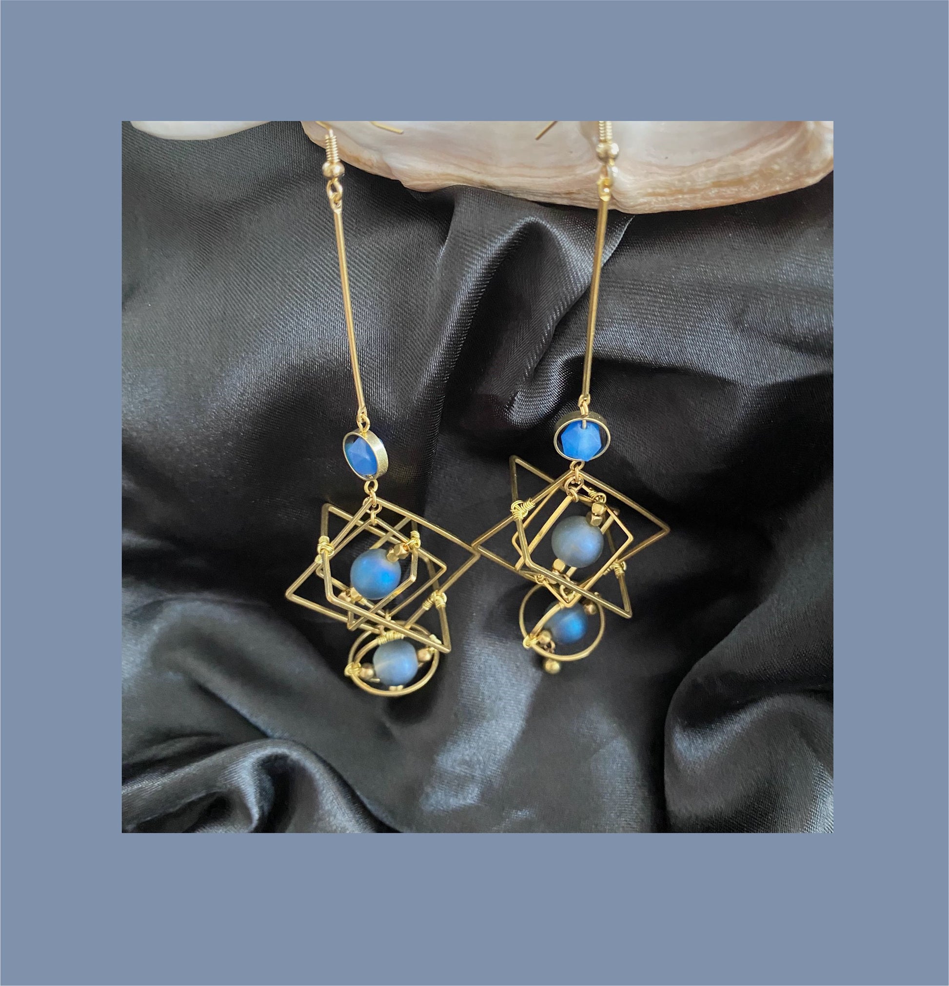 Stylish gold hoop earrings with blue crystal earrings and geometric design