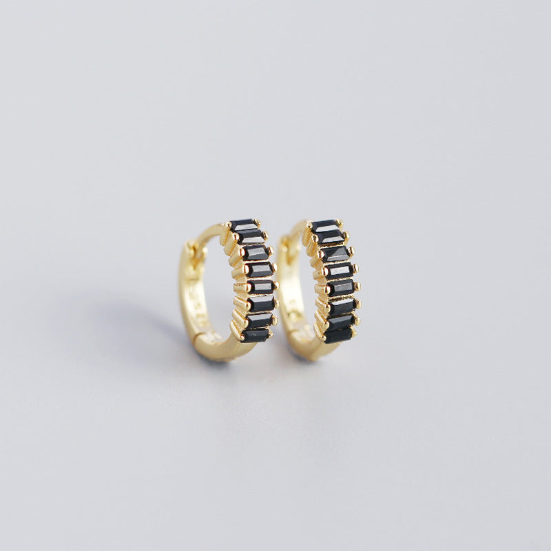 Elegant black and gold huggie hoops, perfect for stylish looks, showcasing dainty stud earrings USA