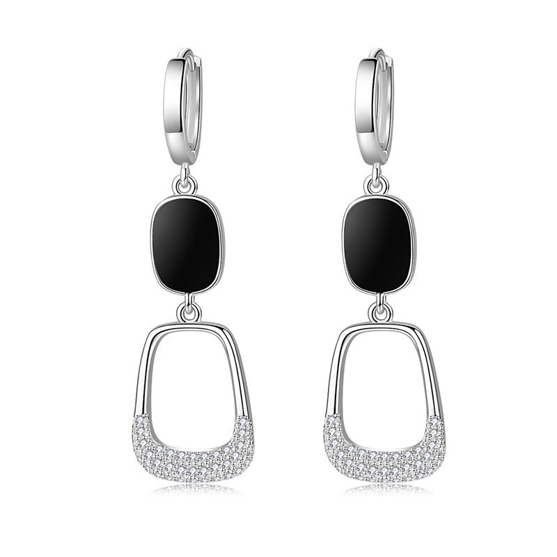 Elegant hollow out diamond earrings featuring black accents and shiny silver details