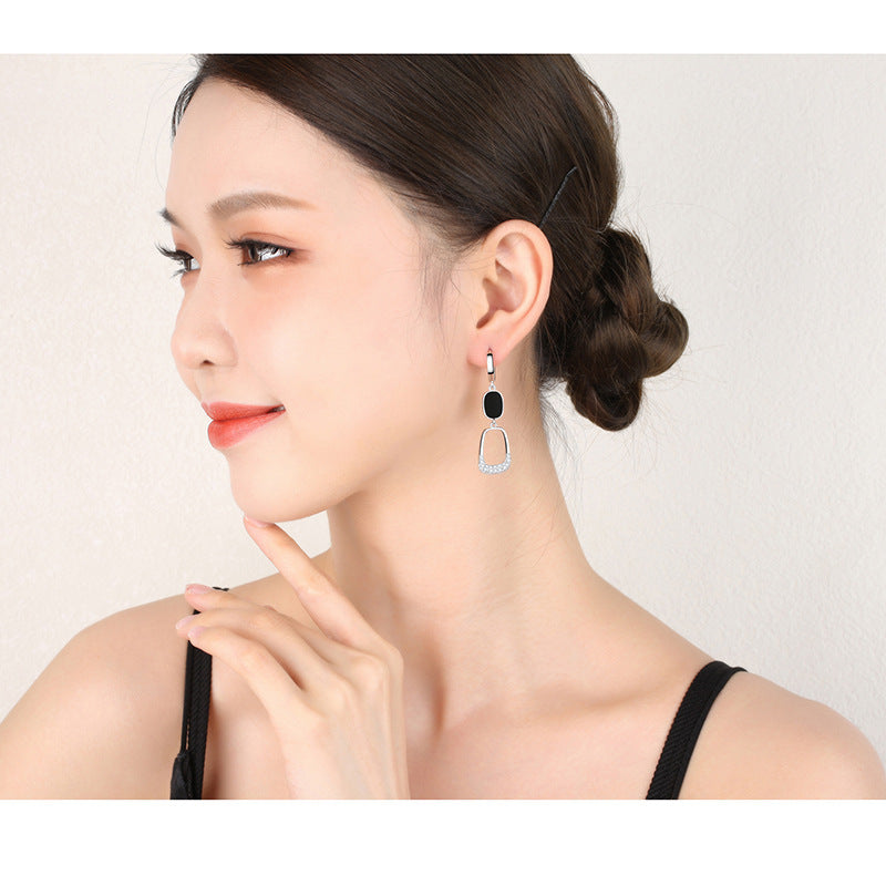 Stylish hollow out diamond earrings displayed on a model with elegant attire, perfect for any occasion